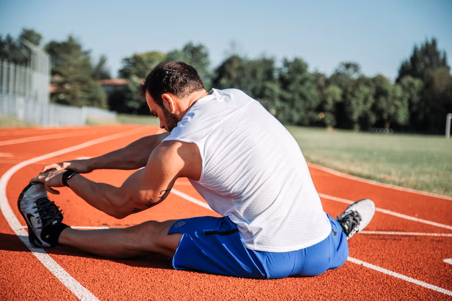 Person stretching outdoors at sunrise